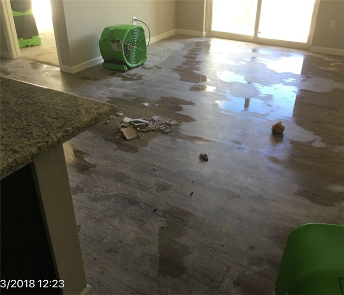 This picture shows water damage with fans drying the floors. 